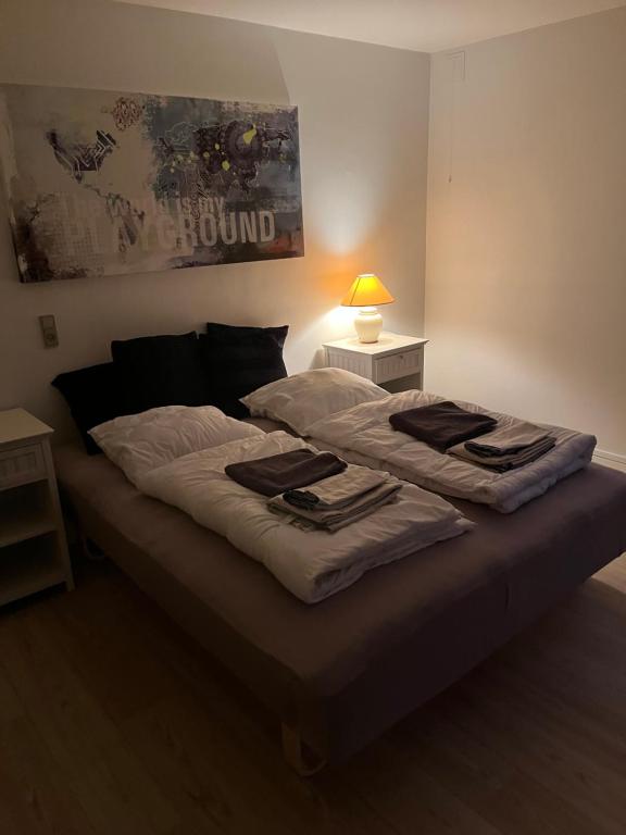 a bed with towels on it in a bedroom at Casa Home of Bricks - Downtown Holidays in Billund