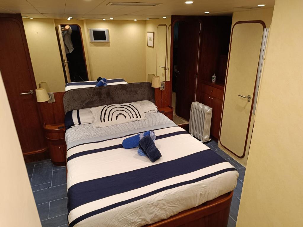 - une chambre avec 2 lits et des serviettes dans l'établissement Amazing boat to sleep in Barcelona, à Barcelone