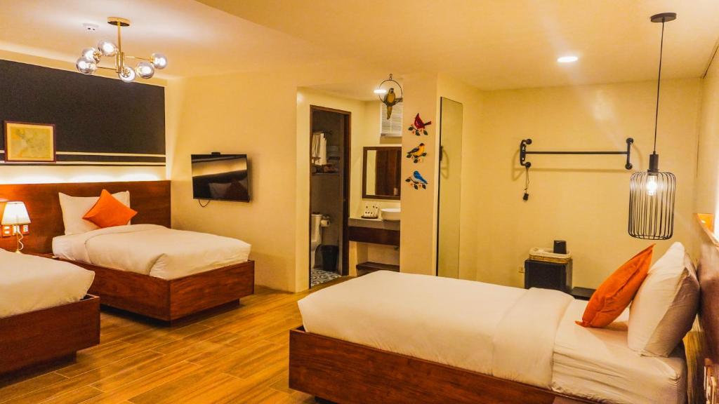 Postel nebo postele na pokoji v ubytování UNWND Boutique Hotel Camiguin