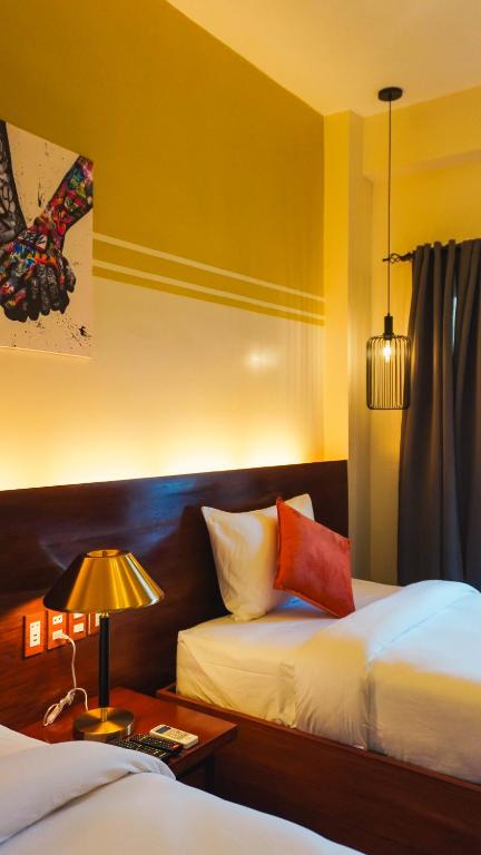 Postel nebo postele na pokoji v ubytování UNWND Boutique Hotel Camiguin