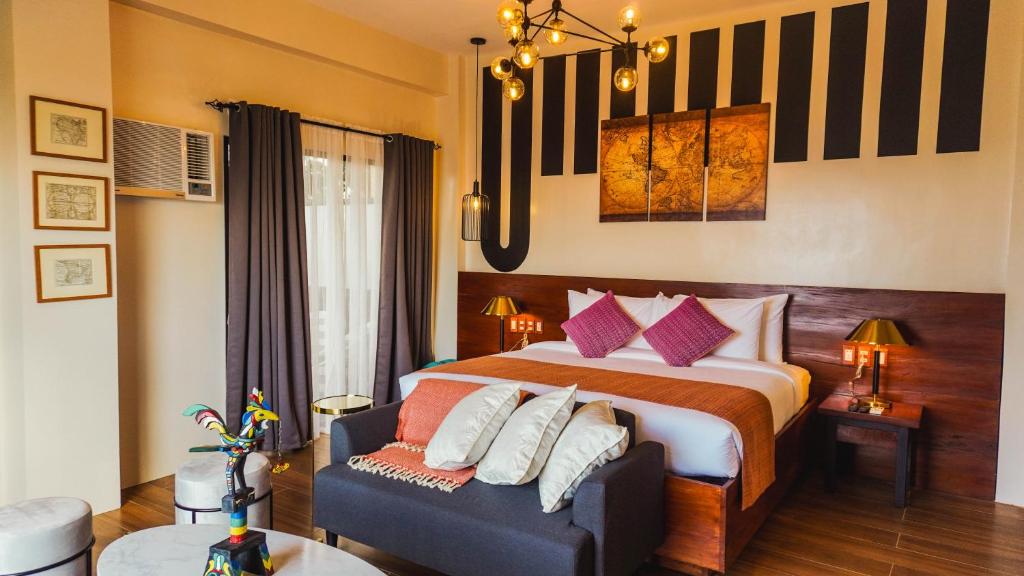 Postel nebo postele na pokoji v ubytování UNWND Boutique Hotel Camiguin