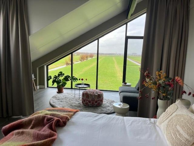 a bedroom with a bed and a large window at @TheLodge 