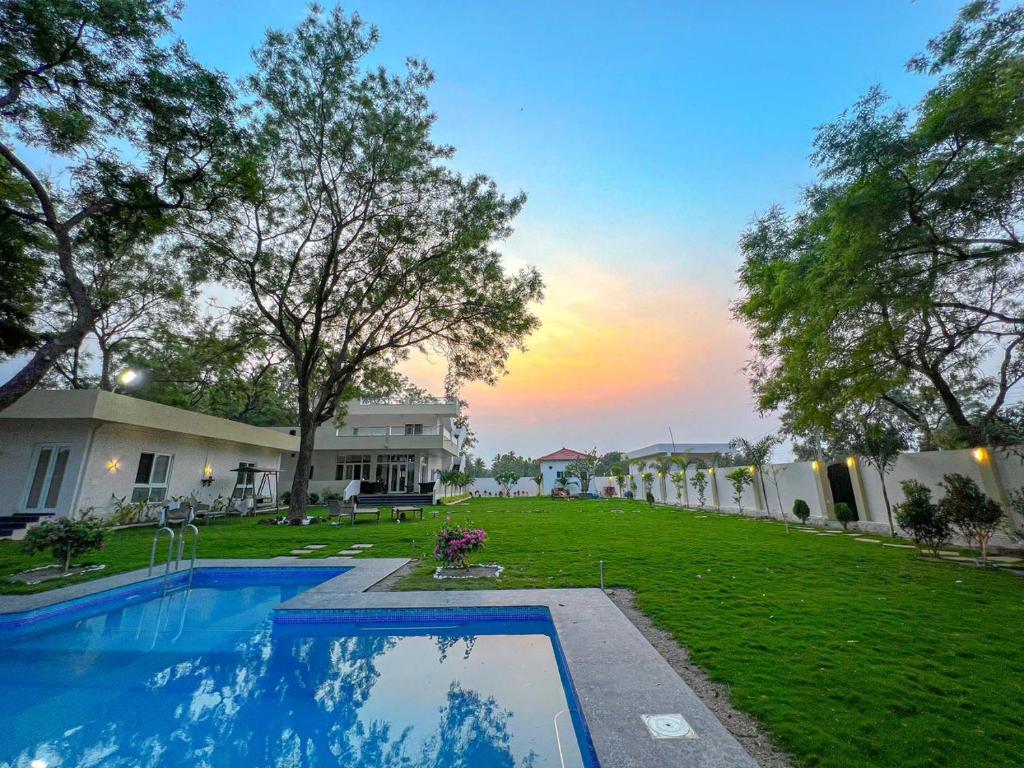The Neem Tree -4br pool villa في شاميربت: منزل فيه مسبح في ساحة