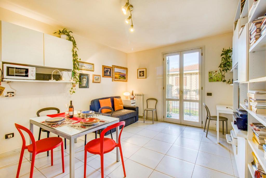 a kitchen and living room with a table and chairs at Appartamento Le Mimose In Lucca - Happy Rentals in Lucca