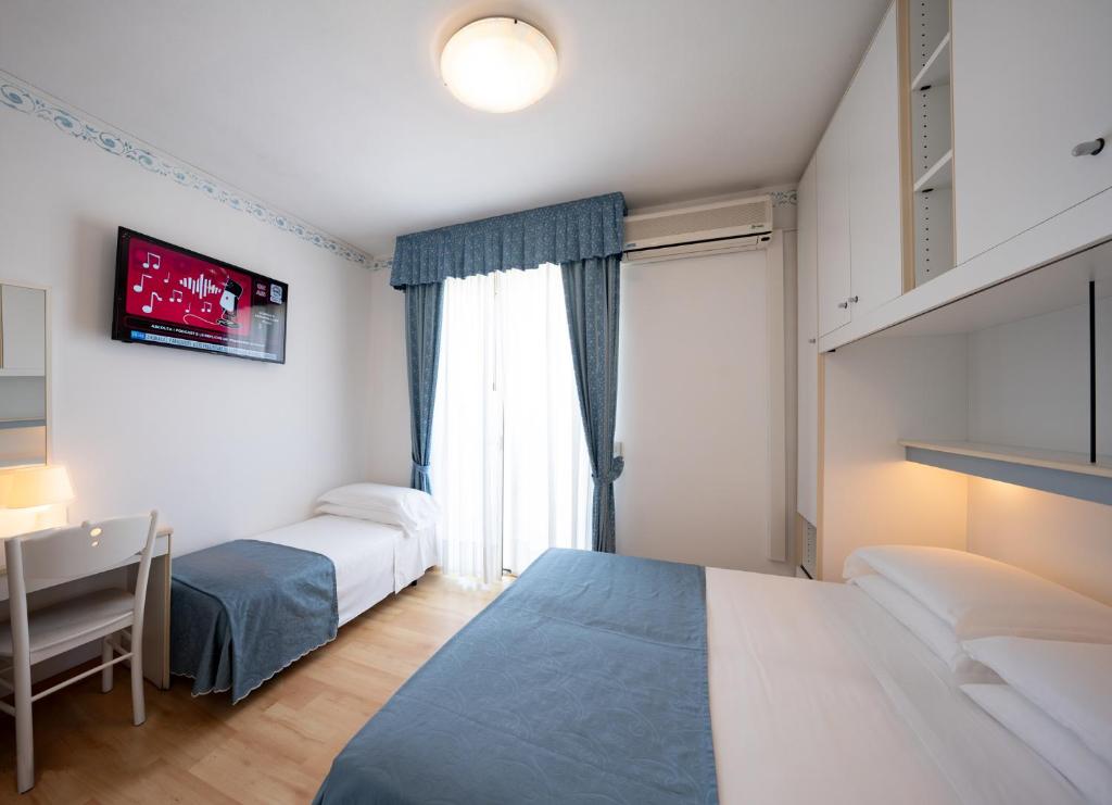 Postel nebo postele na pokoji v ubytování Hotel Laurin