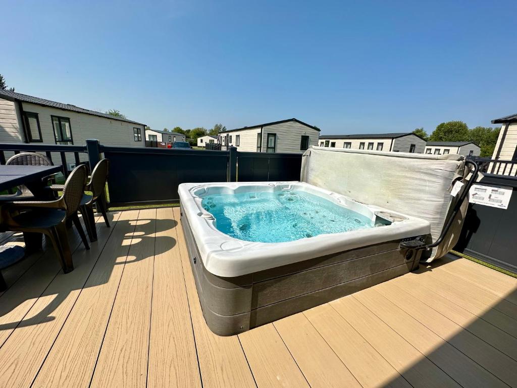 a hot tub sitting on top of a deck at The Boat House, Hot Tub Lodge in South Cerney