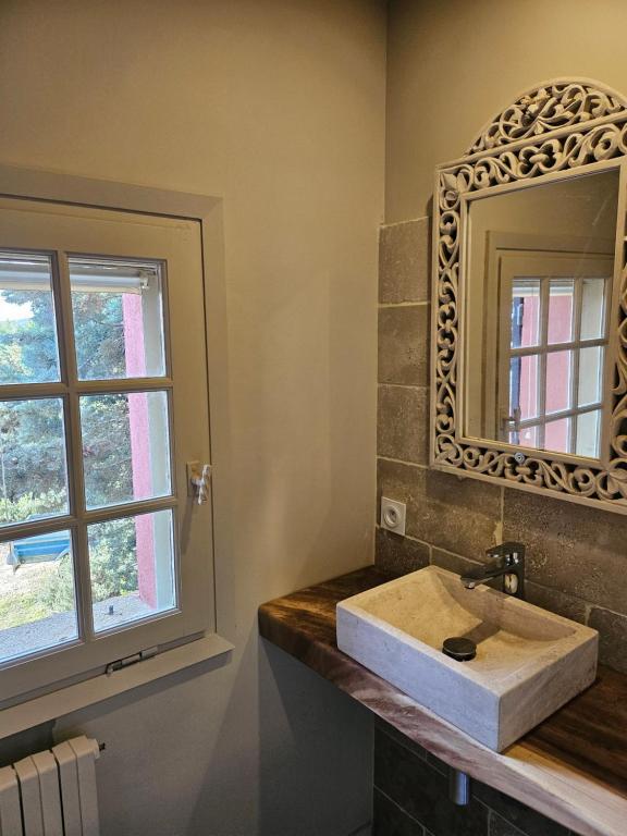 a bathroom with a sink and a mirror and a window at Chambres d&#39;hôtes Le Montagné in Villeneuve-lès-Avignon