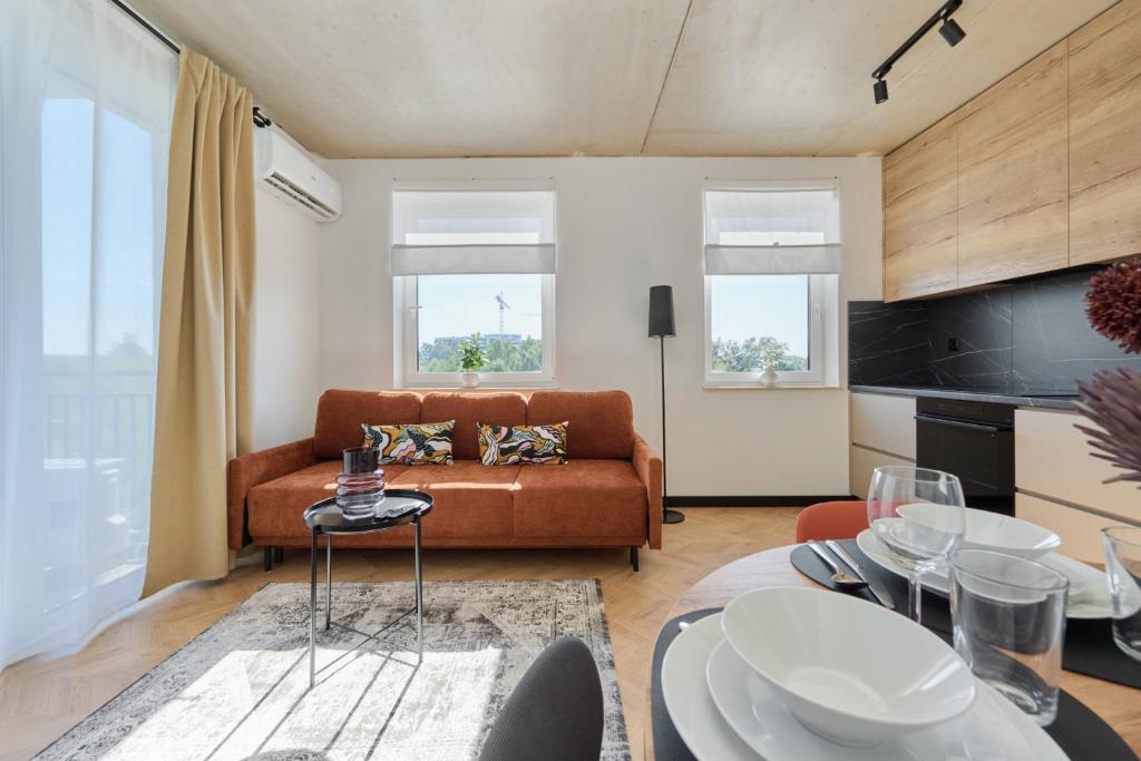 a living room with a couch and a table at Fresh & Stylish Apartments in Poznań with Parking & Balcony by Renters in Poznań