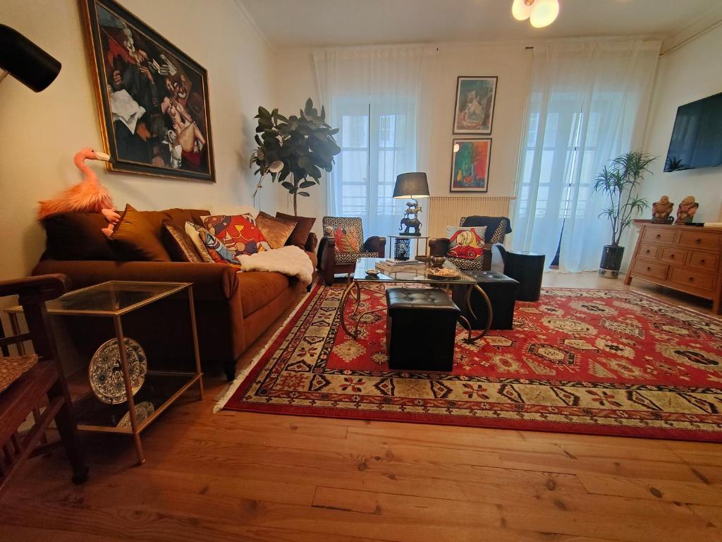 a living room with a couch and a rug at Le Coeur de Cahor! 2 bedroom luxury rental 85m2. in Cahors