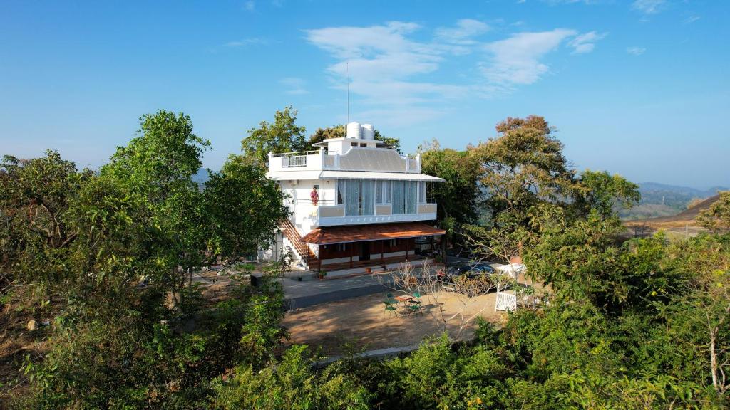 una casa blanca en medio de árboles en PADMA VILLAGE, en Thodupuzha