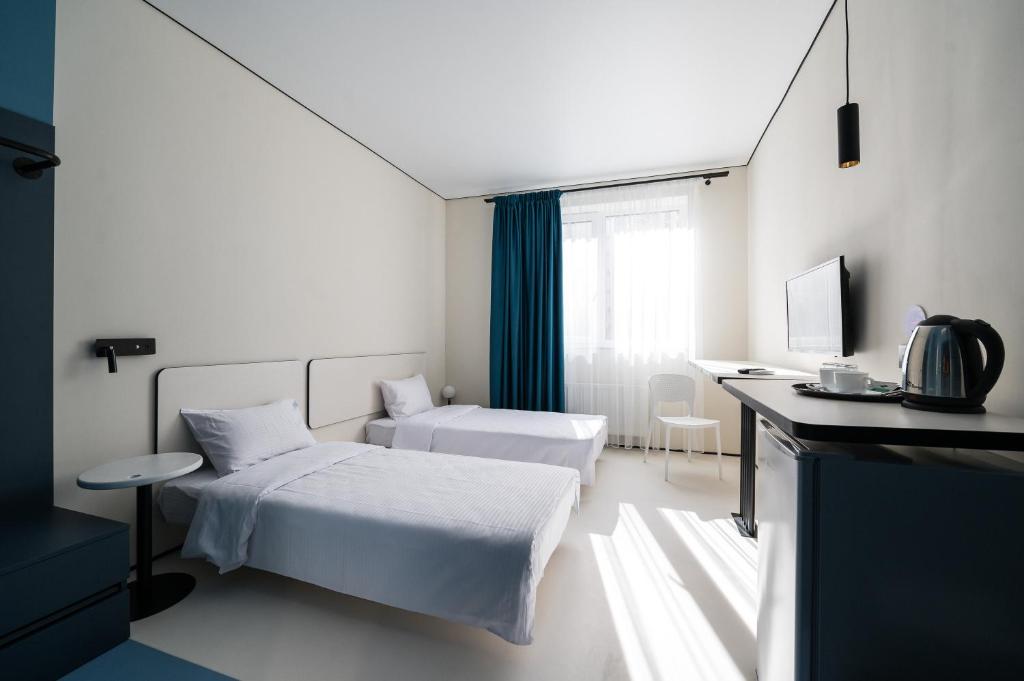 Postel nebo postele na pokoji v ubytování Ultramarinn Hotel