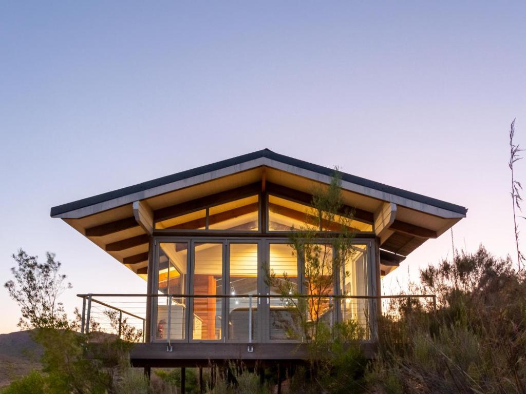a glass house on top of a hill at Landrani Luxury Lodge in Oudtshoorn