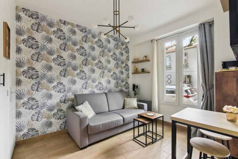 a living room with a couch and a table at 821 Suite Licorne - Superb apartment in Les Lilas