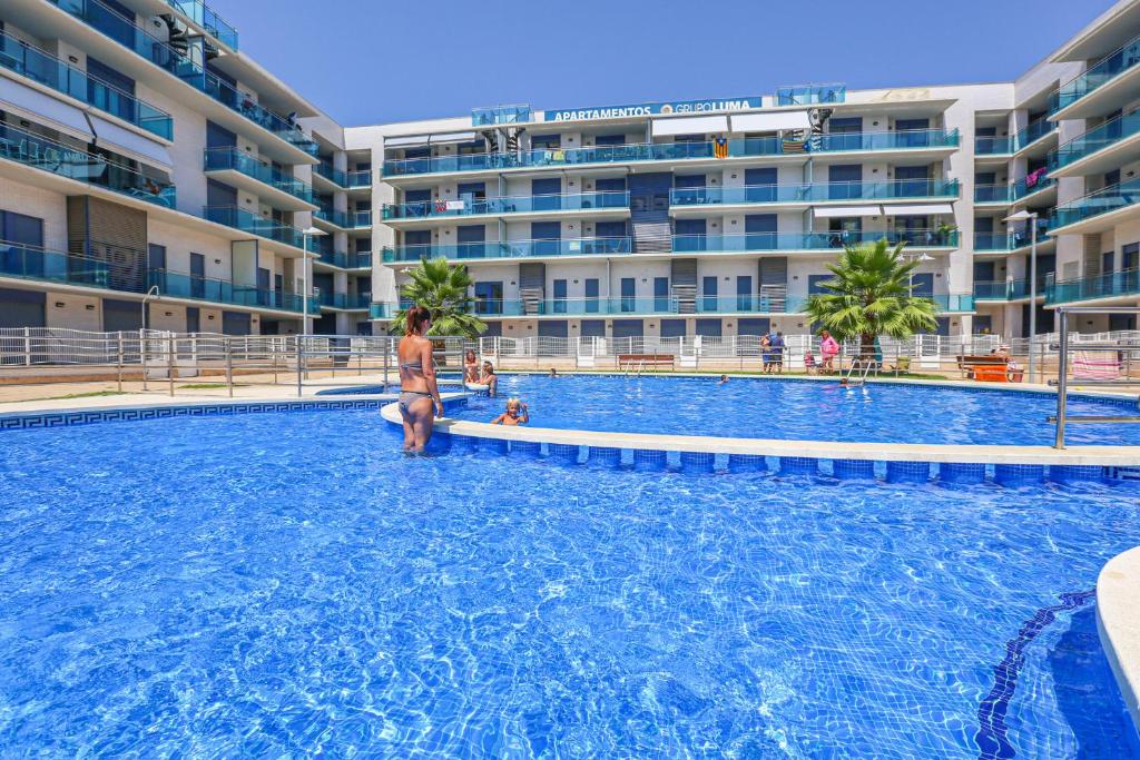 a person standing in the water in a swimming pool at Augusta Litoral - ONLY FAMILIES in Cambrils