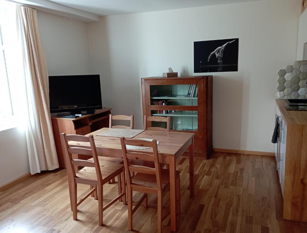 a dining room with a wooden table and chairs at Apartament nad strumykiem Lądek-Zdrój in Lądek-Zdrój