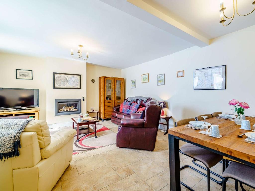 een woonkamer met een bank en een tafel bij 3 Bed in Cockermouth 59384 in Cockermouth