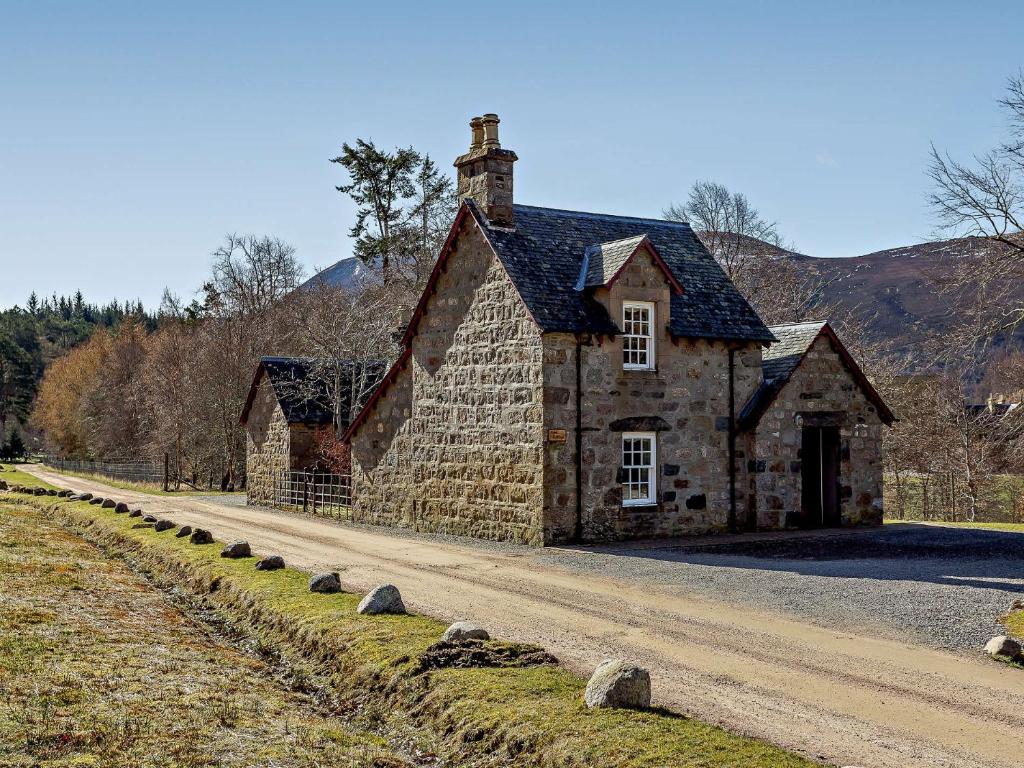 an old stone house on the side of a road at 1 Bed in Alness CA015 in Boath