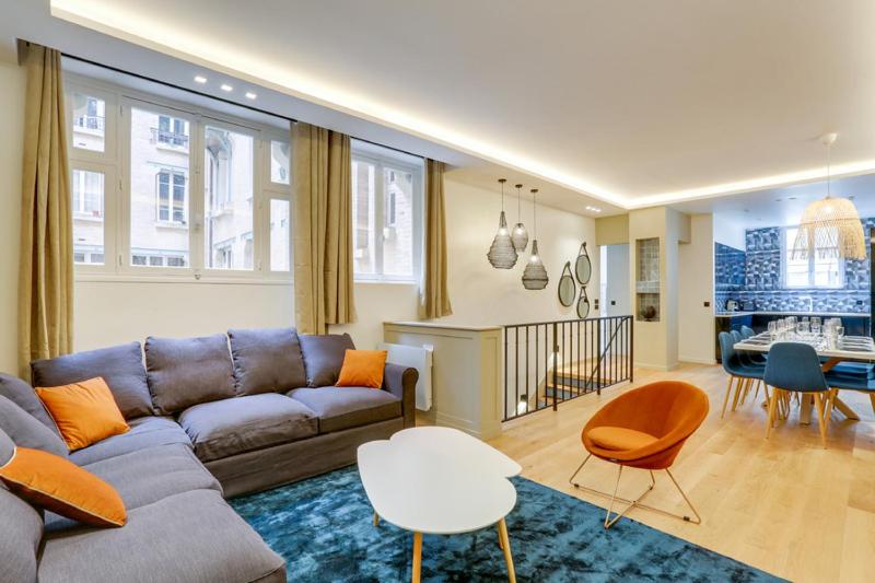 a living room with a couch and a table at 191 Suite Auteuil - Superb apartment in Paris in Paris