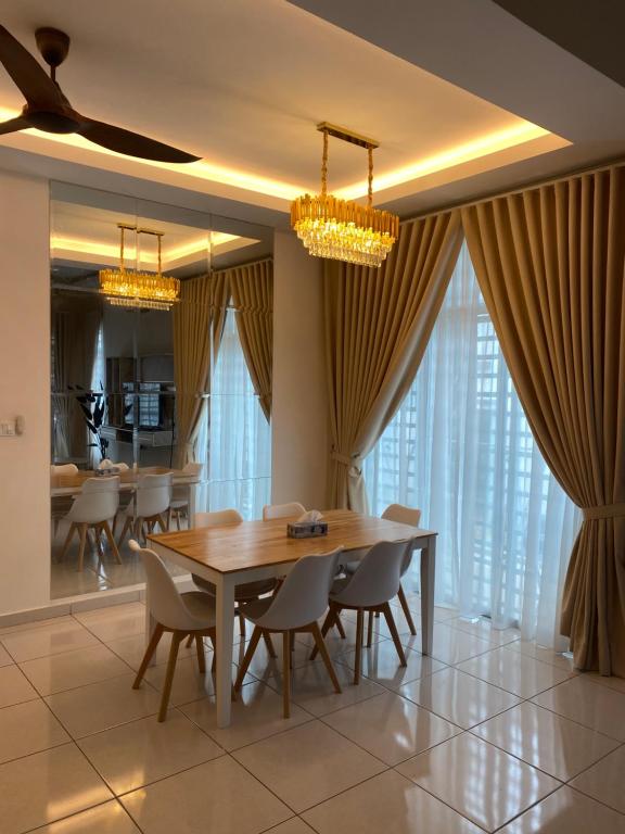 a dining room with a wooden table and chairs at Single storey bungalow Tangkak in Tangkak