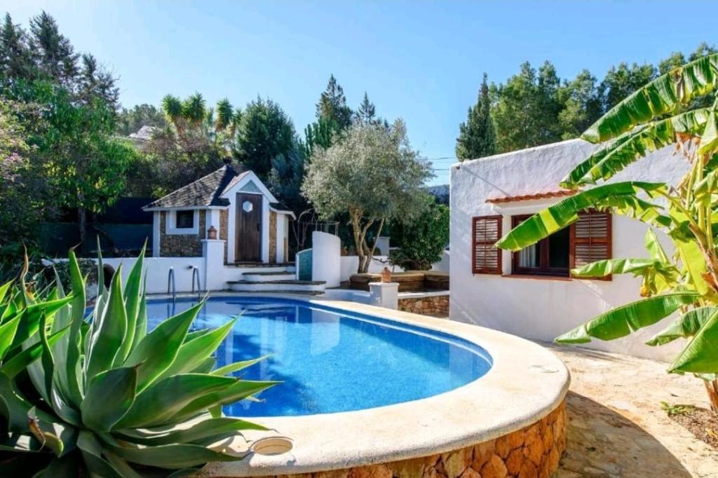 a swimming pool in the backyard of a house at Authentic 4BR Pool & Sauna Villa, Sant Agusti in San Antonio Bay