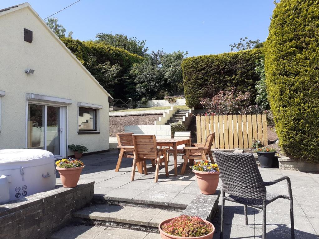 a patio with chairs and a table and a grill at Island view in Spittal