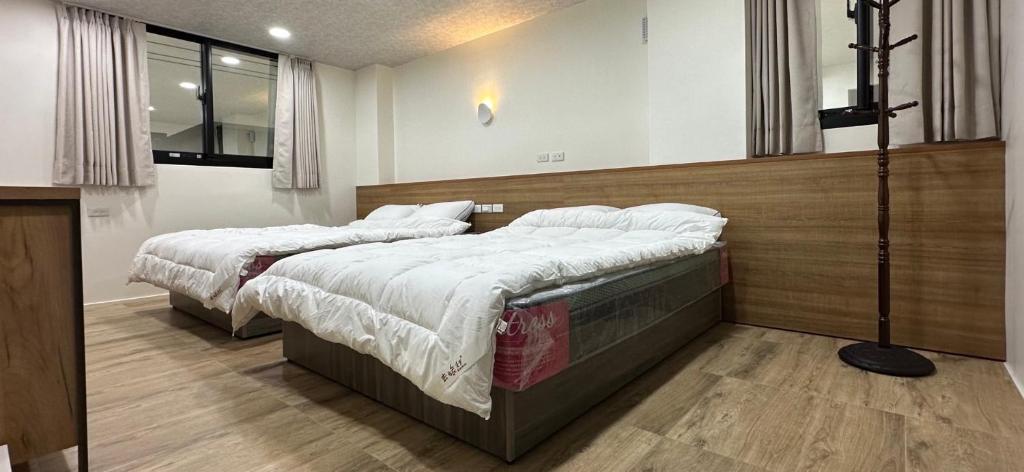 Postel nebo postele na pokoji v ubytování Fulong City B&B