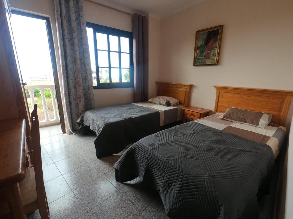 a hotel room with two beds and a window at Twin Room at Villa Lila in Puerto de la Cruz
