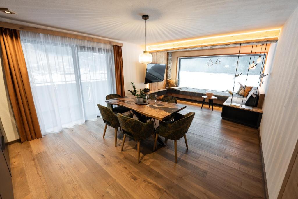 a dining room with a table and chairs and a couch at Apartment Gosauschmied in Gosau