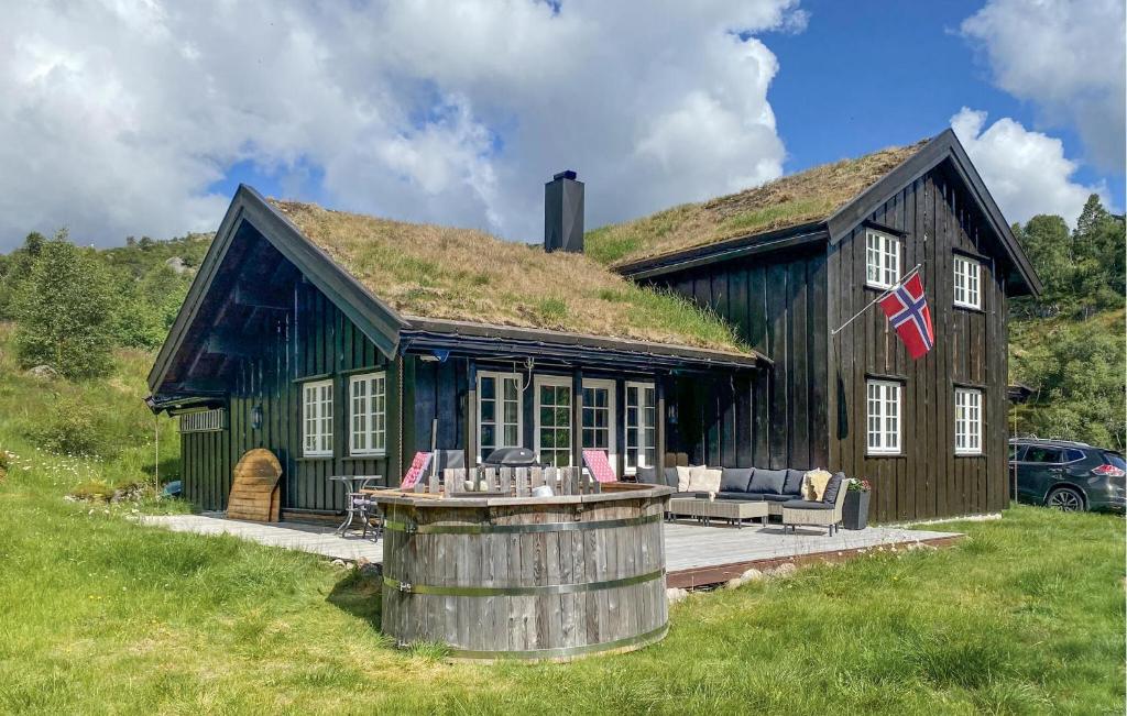 a house with a grass roof with a barrel at Nice Home In seral With Wifi in Åseral