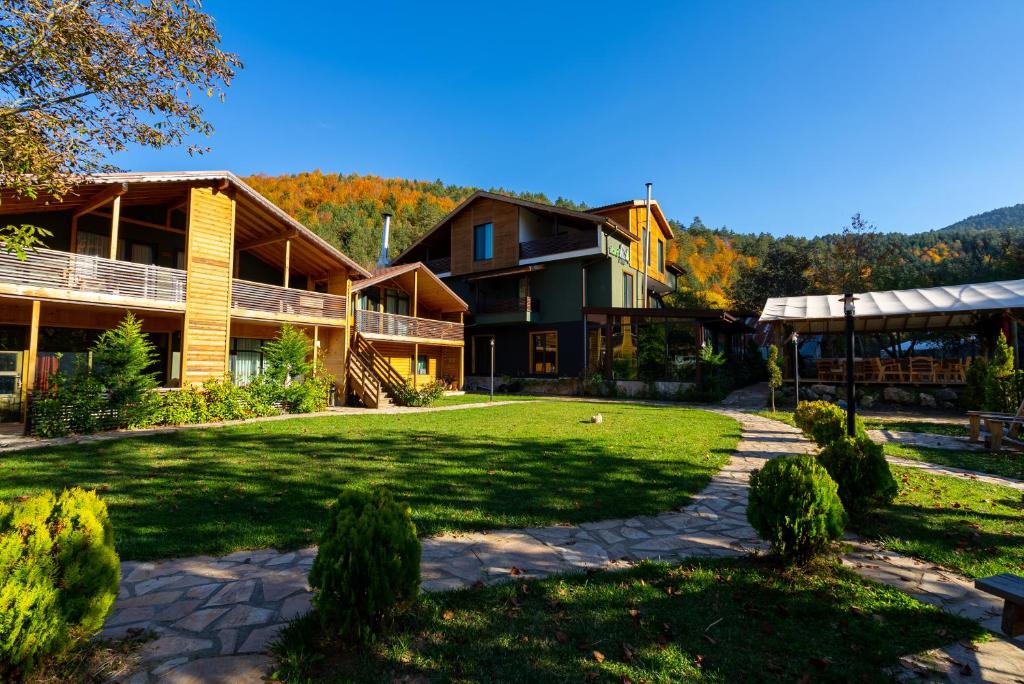 a house with a lawn in front of it at Abant Villa Otel in Bolu