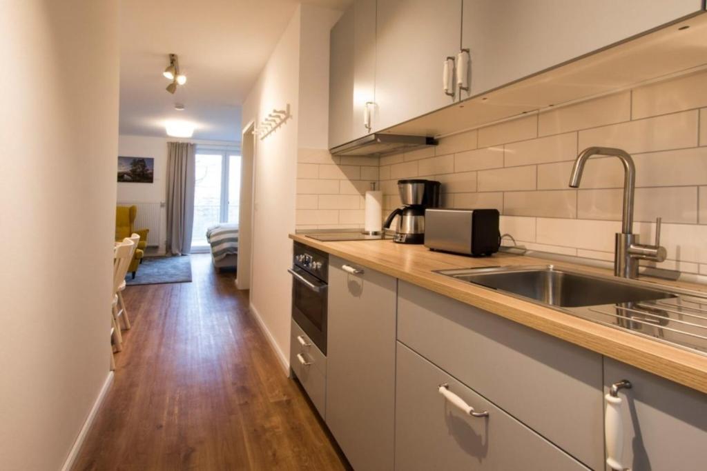 a kitchen with a sink and a counter top at Appartement Seerose in Poppenbüll