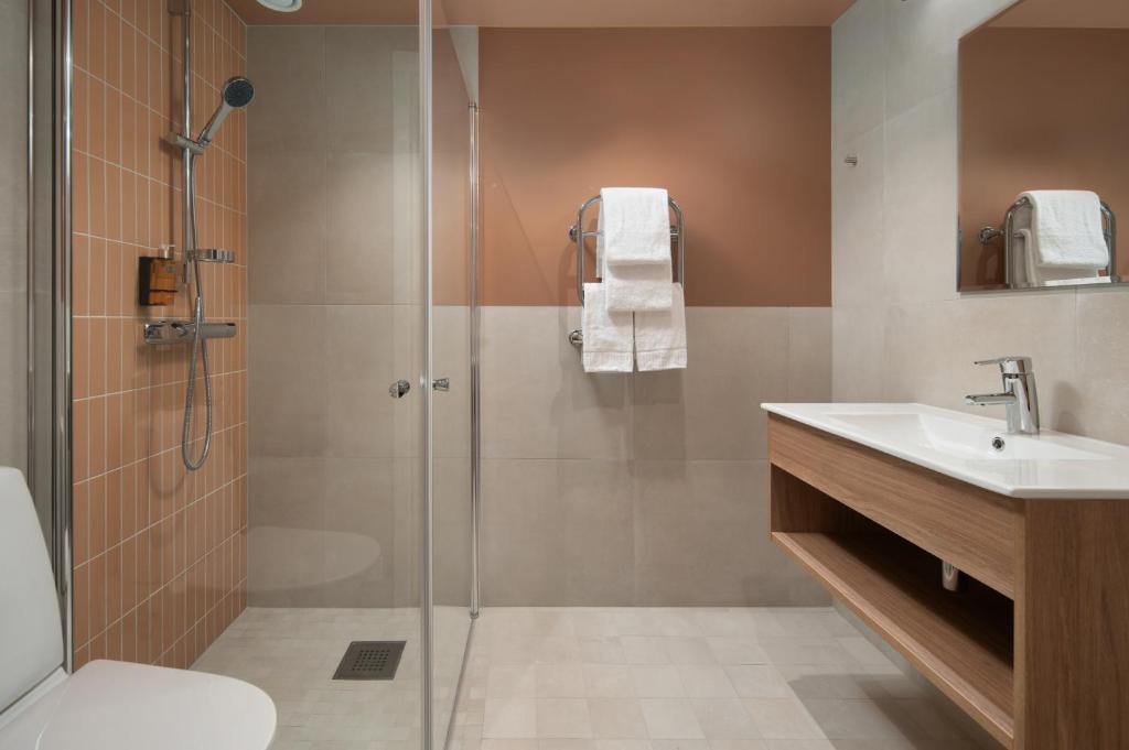 a bathroom with a shower and a sink at Sky Hotel Apartments, Stockholm in Stockholm