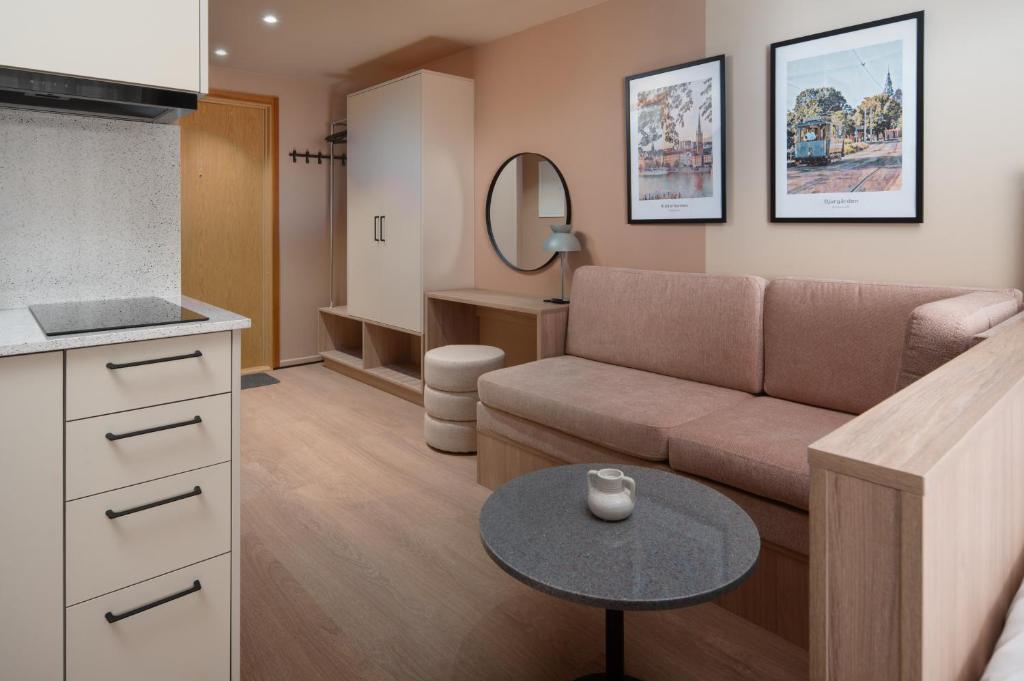 a living room with a couch and a table at Sky Hotel Apartments, Stockholm in Stockholm