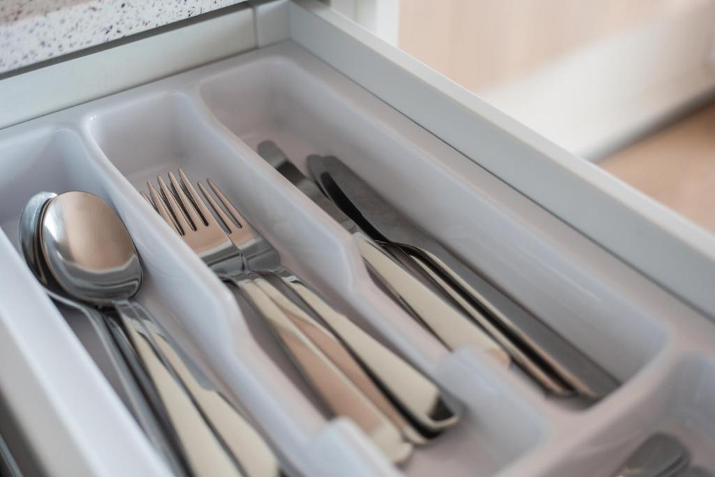 a drawer filled with utensils in a drawer at Sky Hotel Apartments, Stockholm in Stockholm