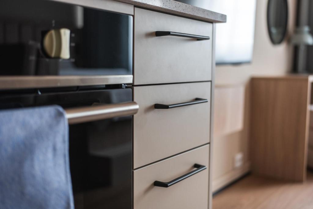 a kitchen drawer with a microwave and a stove at Sky Hotel Apartments, Stockholm in Stockholm