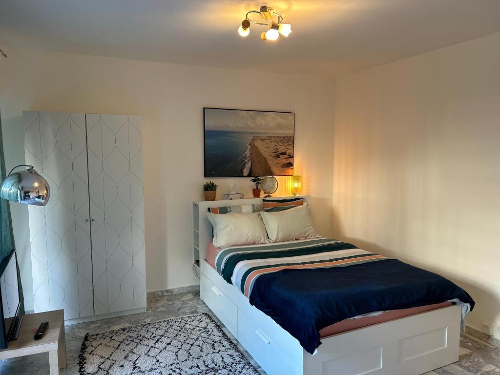 una camera da letto con un letto e un dipinto sul muro di Le Carla studio 2 personne a Nizza