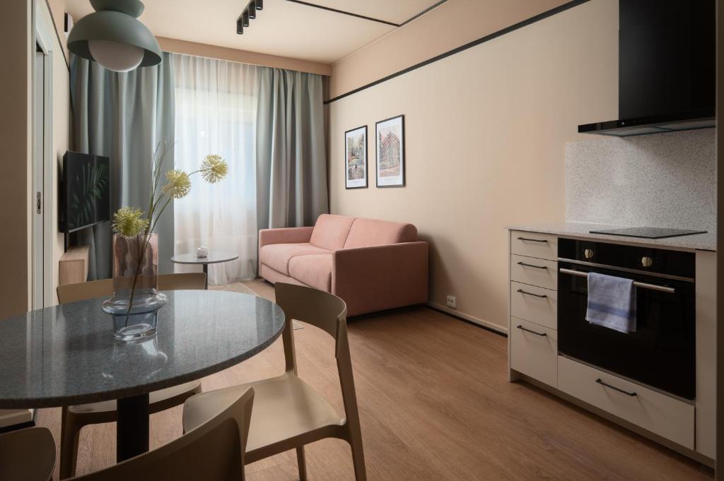 a small living room with a table and a couch at Sky Hotel Apartments, Stockholm in Stockholm