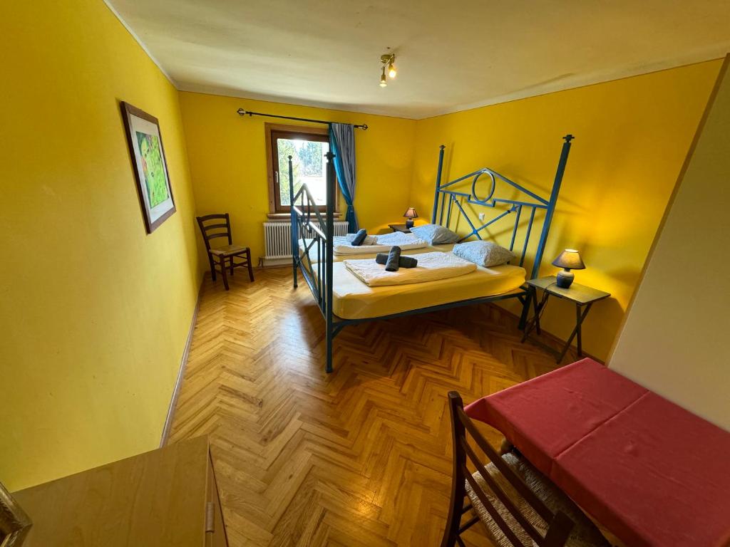 a bedroom with a bed in a yellow room at Jerà am Furtnerteich Hotel-Ristorante&Relax in Mariahof