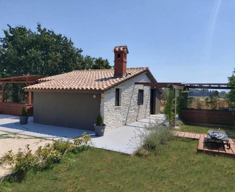 a small house with a brick chimney on top at Casa Colone in Bale