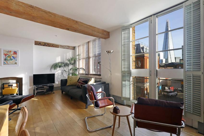 a living room filled with furniture and a large window at Shard View near Borough Market in London