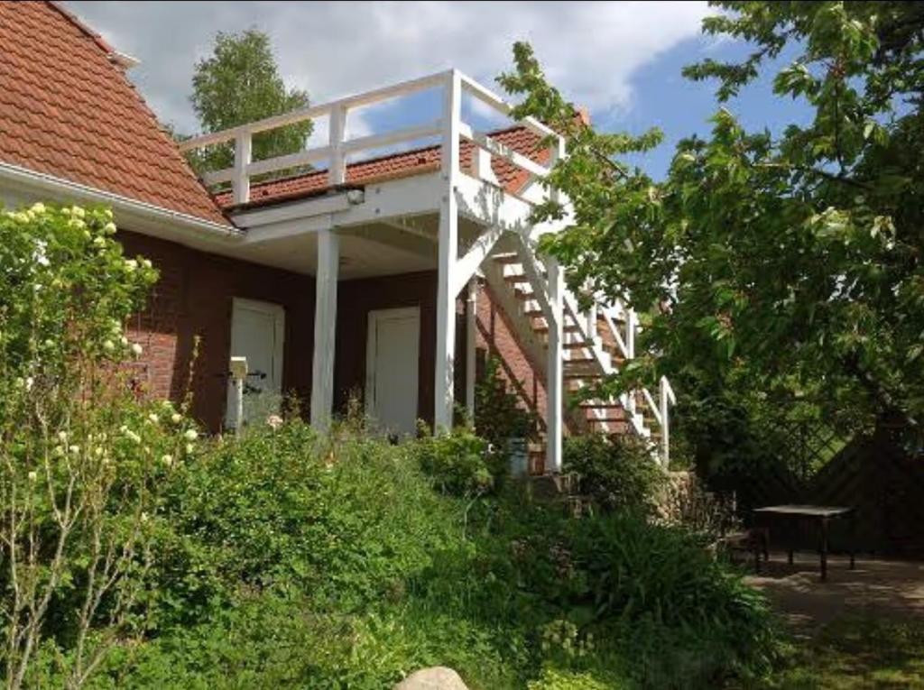 a house with a white staircase on the side of it at Ferienwohnung 2 Schulze in Neustrelitz