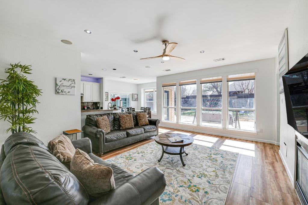 a living room with a couch and a table at Spacious Frisco Family Home Fenced Yard and Office! in Frisco