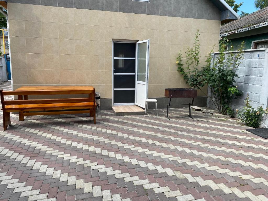 a bench and a table on a patio at Relax House Downtown !!! in Bălţi