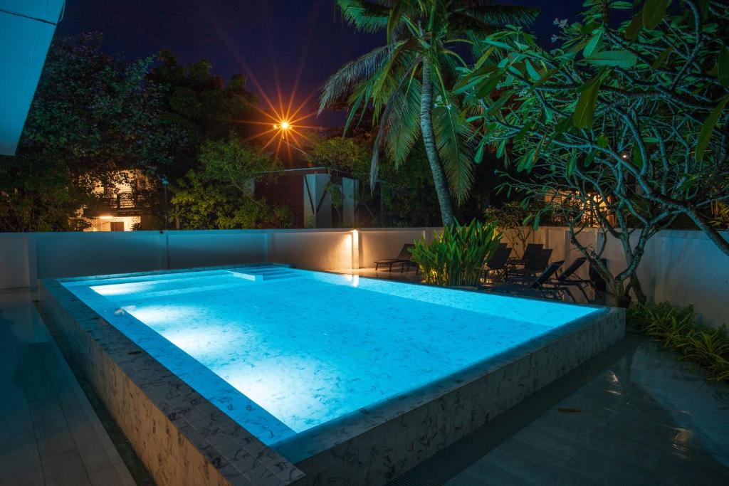 a swimming pool in a backyard at night at Phi Phi Ton Sai Place in Phi Phi Don