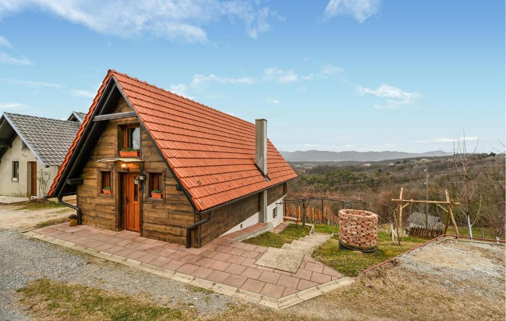 ein kleines Holzhaus mit orangefarbenem Dach in der Unterkunft Cozy Home In Vukovoj With Wi-fi 