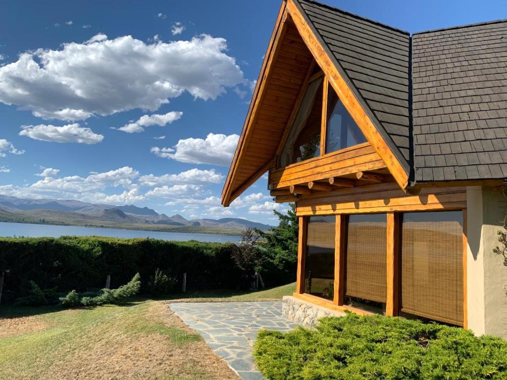 a house with a view of a lake and mountains at Casa con costa del lago in Dina Huapi