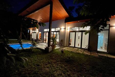 a house with a swimming pool at night at Cheerful 2 bedroom Villa with Pool in Benque Viejo del Carmen