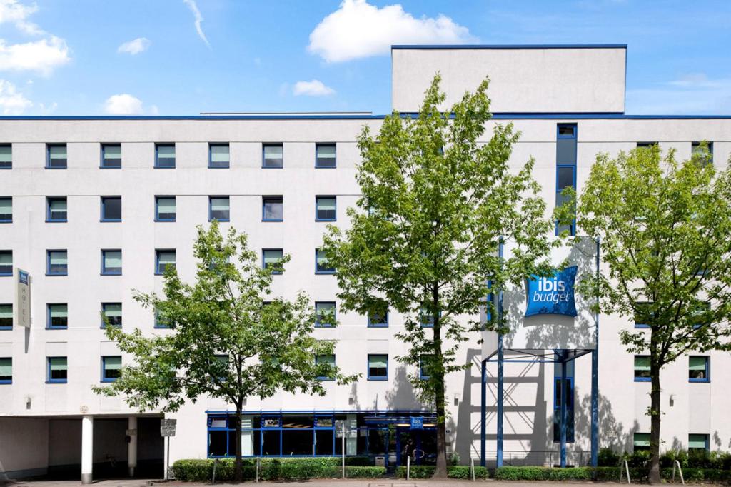 a white building with a sign in front of it at ibis budget Hamburg Altona in Hamburg