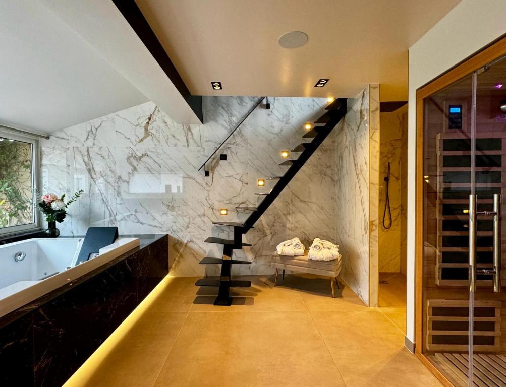 La salle de bains est pourvue d'une baignoire et d'un escalier. dans l'établissement La Croisée des Sens, à Croisy-sur-Eure
