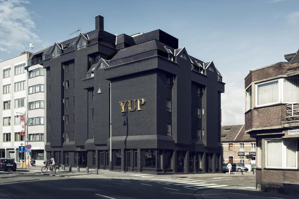 a large building with a large clock on the side of it at YUP Hotel in Hasselt